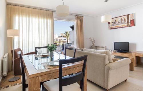 a dining room and living room with a table and a couch at 2 Bedroom Nice Apartment In Roldán in Los Tomases