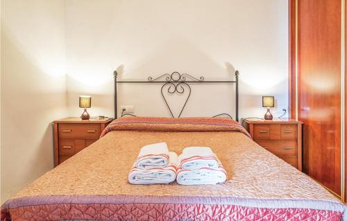 a bedroom with a bed with two towels on it at Beautiful Apartment In Crdoba With Kitchenette in Córdoba