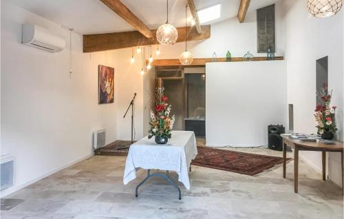 a living room with a table with flowers on it at Mas Melusine in Caderousse