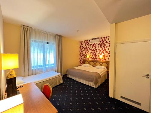 Postel nebo postele na pokoji v ubytování Park Villa Hotel