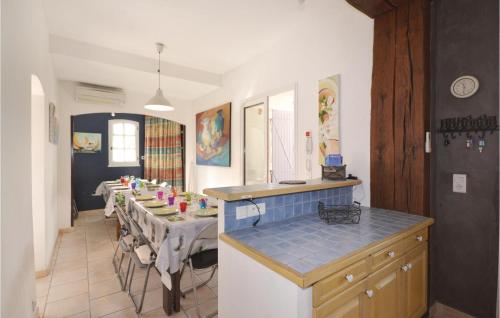 a kitchen with a table and a dining room at Mas Melusine in Caderousse