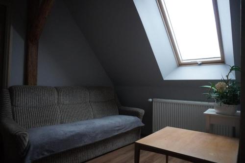 a living room with a couch and a window at UDany Wypoczynek in Wojanów