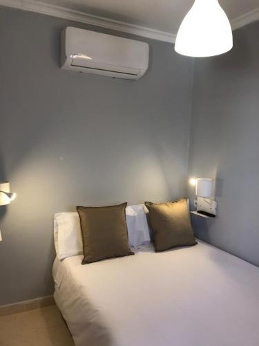 a room with a bed with two pillows on it at Home SEA&DREAMS OldTown II in Calpe