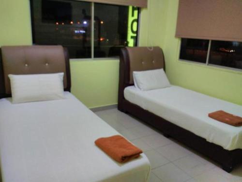 Pokój z 2 łóżkami i oknem w obiekcie Hotel Paka INN w mieście Paka