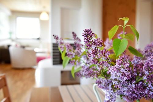 a vase of purple flowers sitting on a table at Borová Sihoť ATC and penzion in Liptovský Hrádok
