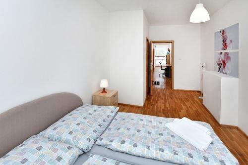 a bedroom with a bed with a blue comforter at Borová Sihoť ATC and penzion in Liptovský Hrádok