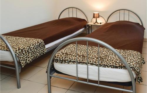 deux lits côte à côte dans une pièce dans l'établissement Holiday Home Lieu Dit Les Pavillons, à Deux-Jumeaux