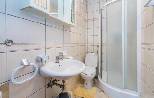 a bathroom with a sink and a toilet and a shower at Awesome Apartment In Banjol With 2 Bedrooms And Wifi in Banjol