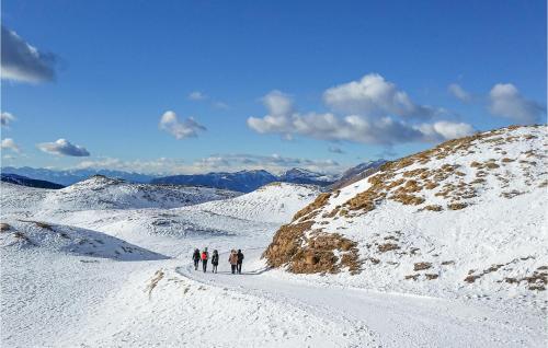 a group of people walking on a snow covered mountain at 2 Bedroom Beautiful Home In Terzolas in Terzolas