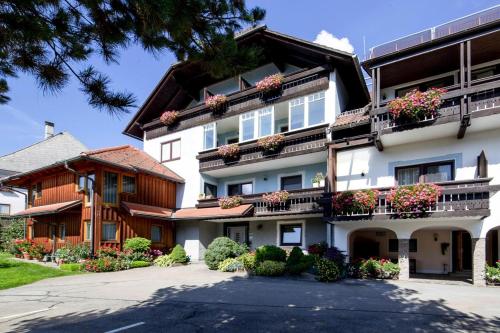 a large white building with flower boxes on the balconies at Holiday flats in St Georgen am Kreischberg in Sankt Georgen ob Murau