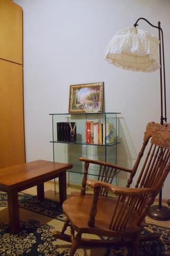 a room with a table and a chair and a lamp at Omodarme52 in Pisa