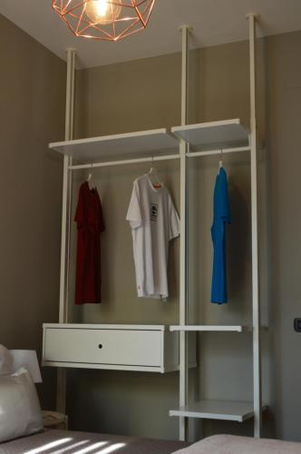 a bedroom with a closet with a white shelving unit at Omodarme52 in Pisa