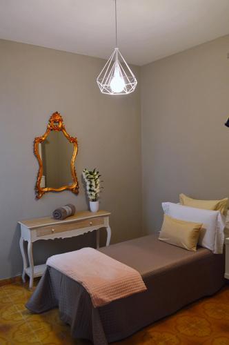 a bedroom with a bed and a mirror at Omodarme52 in Pisa