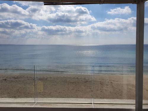 a view of the beach from a window at Salento Sottovento Luxury BeB in Torre Lapillo