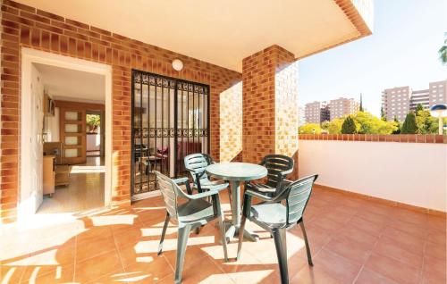 a patio with a table and chairs on a balcony at Pet Friendly Apartment in Oropesa del Mar