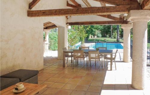 un patio avec une table et des chaises et une piscine dans l'établissement Gorgeous Home In Callian With Kitchen, à Callian