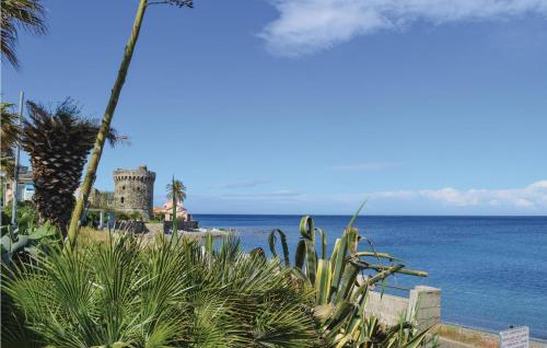 a view of the ocean and a castle on the beach at Stunning Apartment In Bastia in Bastia