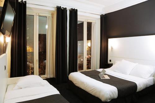 a hotel room with two beds and a window at Hôtel de l'Exposition - République in Paris