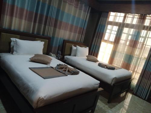 Postel nebo postele na pokoji v ubytování Hera Hotel Kampala