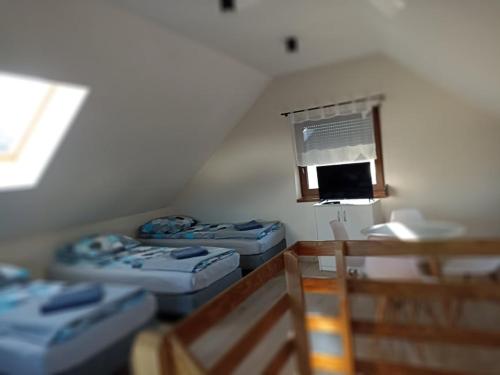 a room with three blue beds and a window at Mała Chatka domek Zator Oświęcim in Polanka Wielka