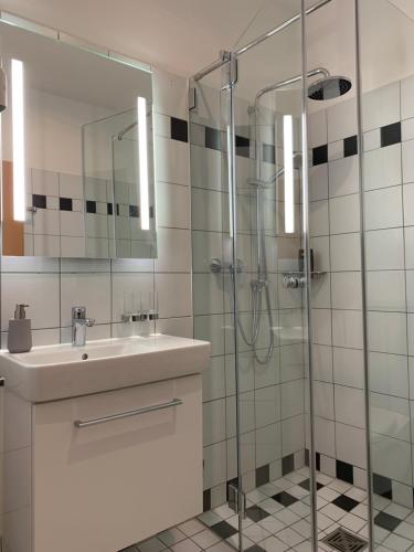 a bathroom with a sink and a glass shower at Landgasthaus-Hotel Wenninghoff in Dreierwalde