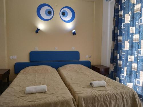A bed or beds in a room at Antonios Hotel
