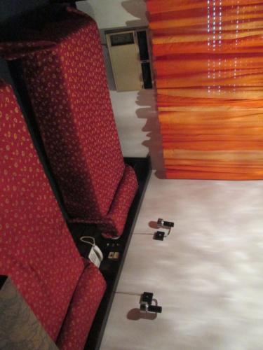 a pair of red seats on a train at Hotel Nahuel in Rosario
