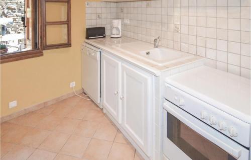 a white kitchen with a sink and a dishwasher at 2 Bedroom Gorgeous Home In Bonnevaux in Bonnevaux-et-Hiverne