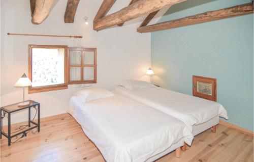 a bedroom with a white bed and a window at 2 Bedroom Gorgeous Home In Bonnevaux in Bonnevaux-et-Hiverne