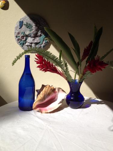 two blue vases sitting on top of a table at Sana El Jardin Secreto in Santiago de los Caballeros