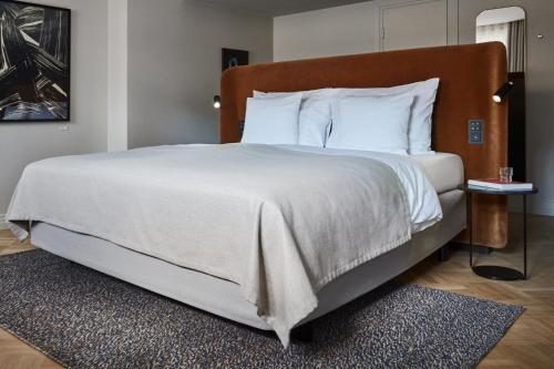 a bedroom with a large bed with white sheets and pillows at Solo Sokos Hotel Torni Helsinki in Helsinki