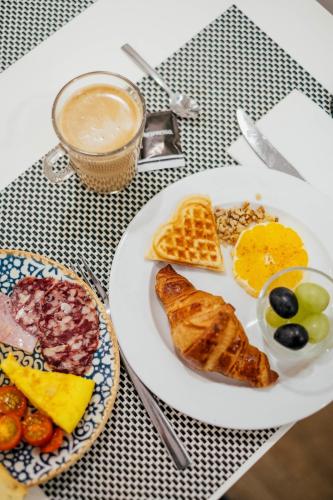 a plate of breakfast food on a table at Hotel Cetina Murcia in Murcia