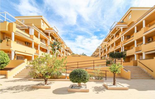 a building with stairs and trees in a courtyard at Cozy Apartment In Denia With Wifi in Denia