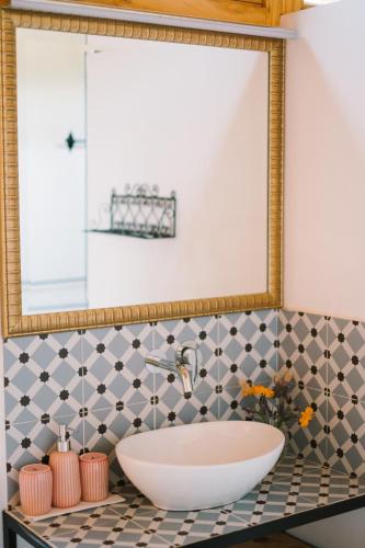 a bathroom with a large mirror and a sink at miCielo - Baumhäuser in Vejer de la Frontera