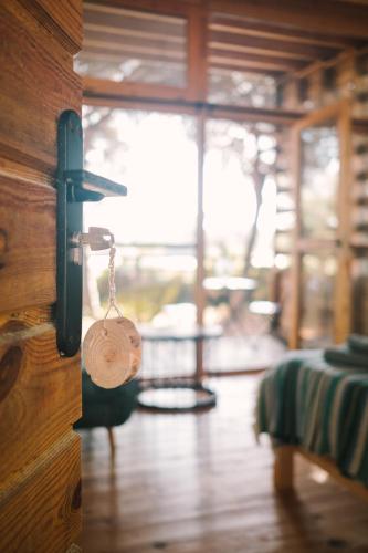 a wooden door with a key in a room at miCielo - Baumhäuser in Vejer de la Frontera