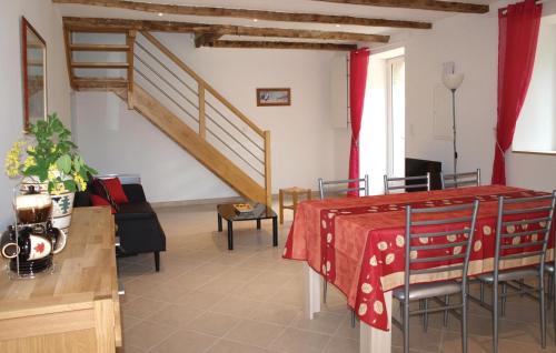 a living room with a table and a staircase at Stunning Home In Pleumeur Bodou in Pleumeur-Bodou