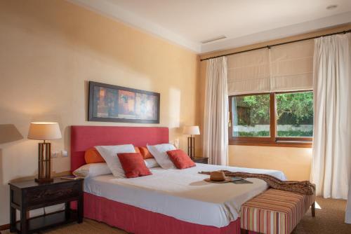 a bedroom with a large bed and a window at Villa Lila in Benalup Casas Viejas