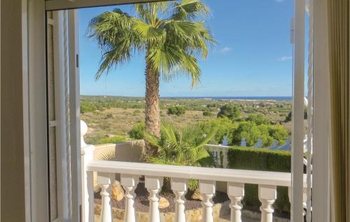 a view from a balcony with a palm tree at Beautiful Home In Quesada-Rojales in Rojales