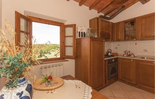 a kitchen with wooden cabinets and a table and a window at Apt 8 in Querce