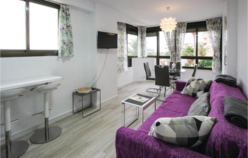 a living room with a purple couch and a table at Amazing Apartment In Torrevieja in La Mata