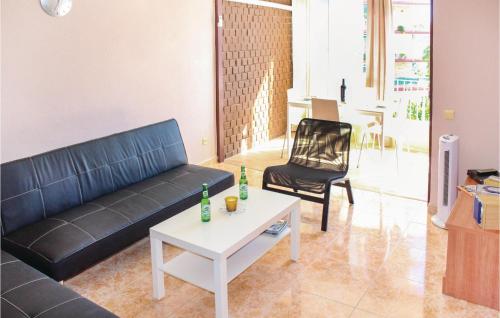 a living room with a couch and a table and a chair at Cozy Apartment In Alicante With Wifi in Alicante