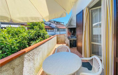 a white table and chairs on a balcony at Calabria G41 in Lido di Pomposa