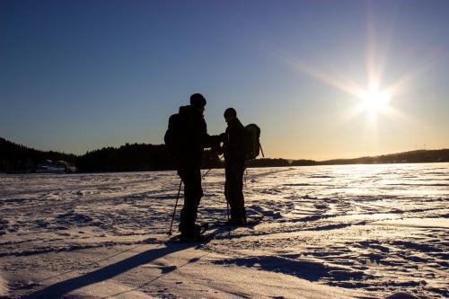 two people standing on skis in the snow at Hotell Tjamstan Malå in Malå