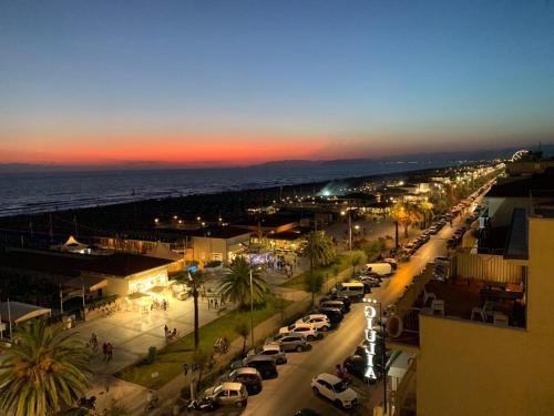 a busy city street with cars parked on the street at Hotel Sole E Mare in Lido di Camaiore