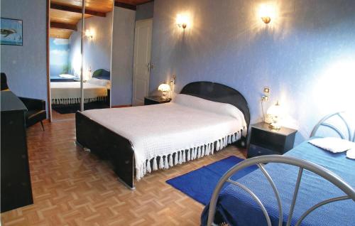 a bedroom with two beds and a mirror at Les Nouelles in Les Magnils
