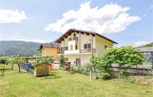 a house in a field with a yard at 2 Bedroom Amazing Home In Sovramonte in Sovramonte