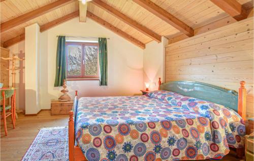 a bedroom with a bed in a room with wooden ceilings at Beautiful Home In Telve Di Sopra With 2 Bedrooms And Wifi in Telve