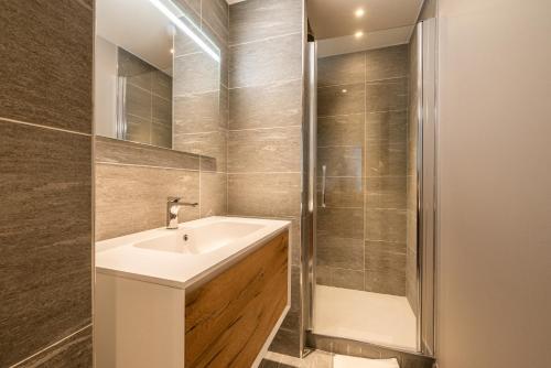 a bathroom with a sink and a shower at Residence Phoenix Courchevel Village - by EMERALD STAY in Courchevel