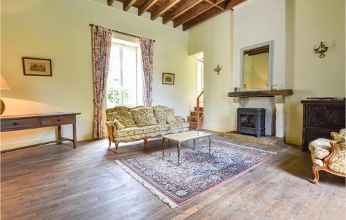 a living room with a couch and a fireplace at Nice Home In La Chapelle Hermier in La Chapelle-Hermier