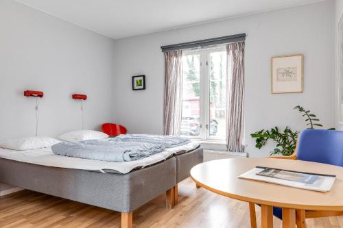 a bedroom with a bed and a table at STF Baskemölla Hostel in Simrishamn